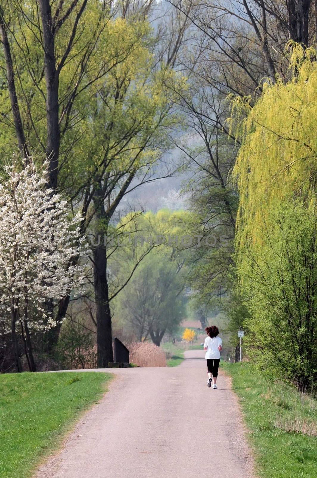 This image shows a jogging woman in a park 