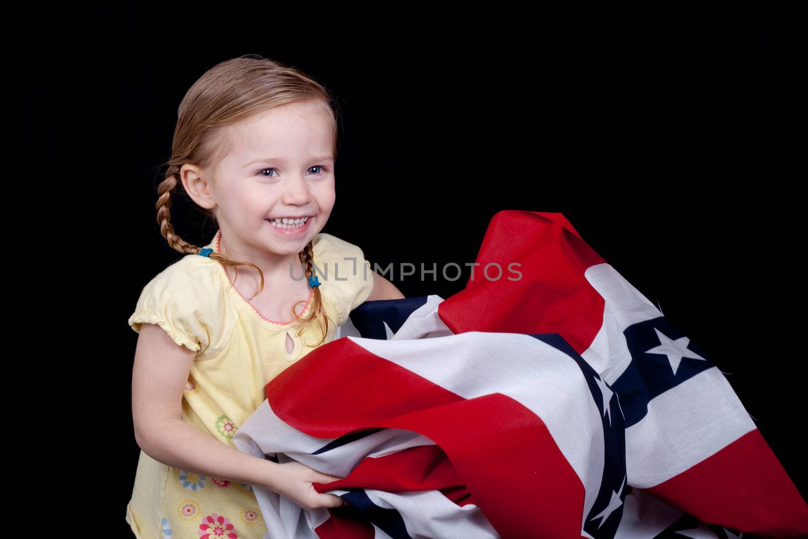 A cute girl folding/holding the American Flag