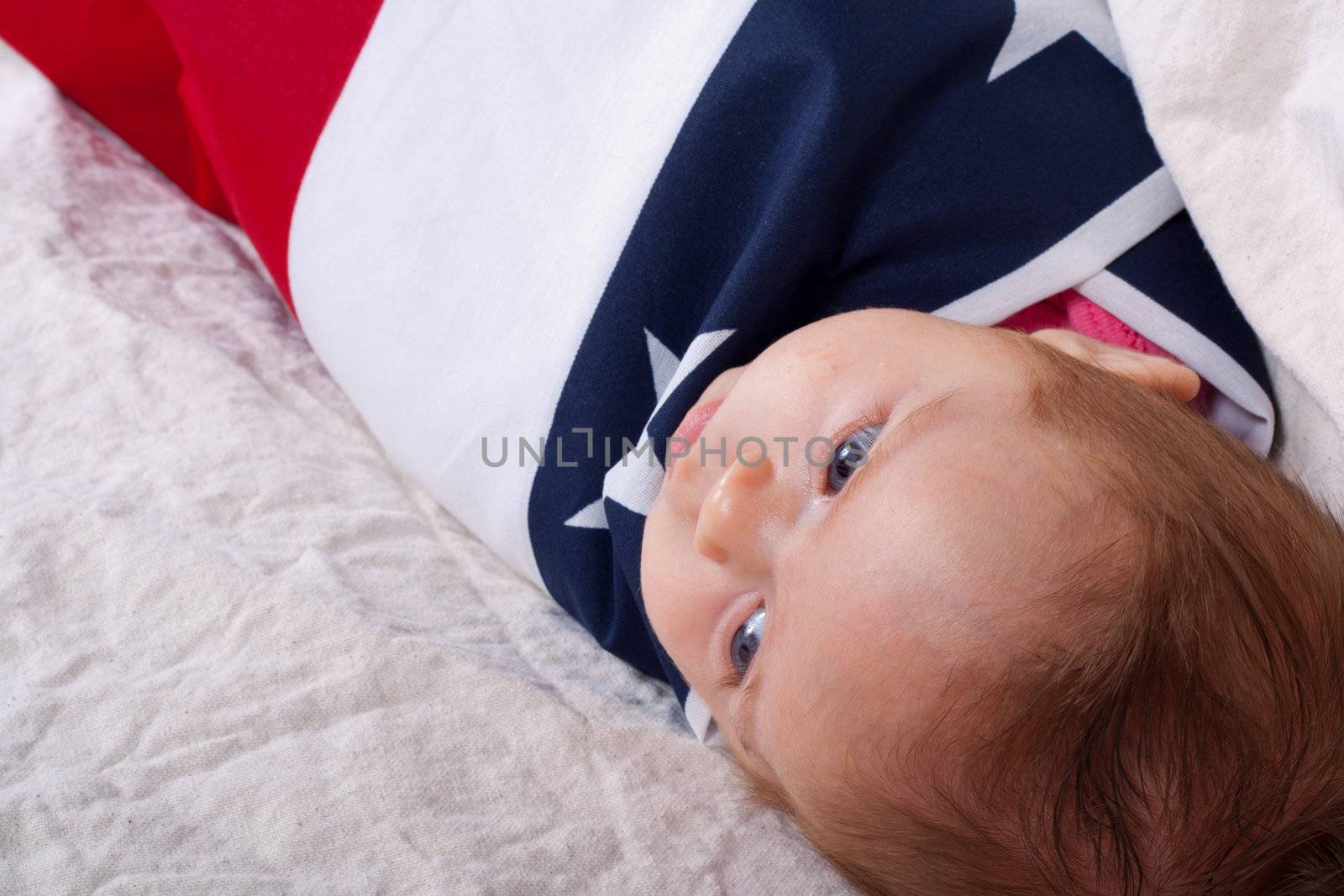 American baby wrapped and protected by the American Flag.