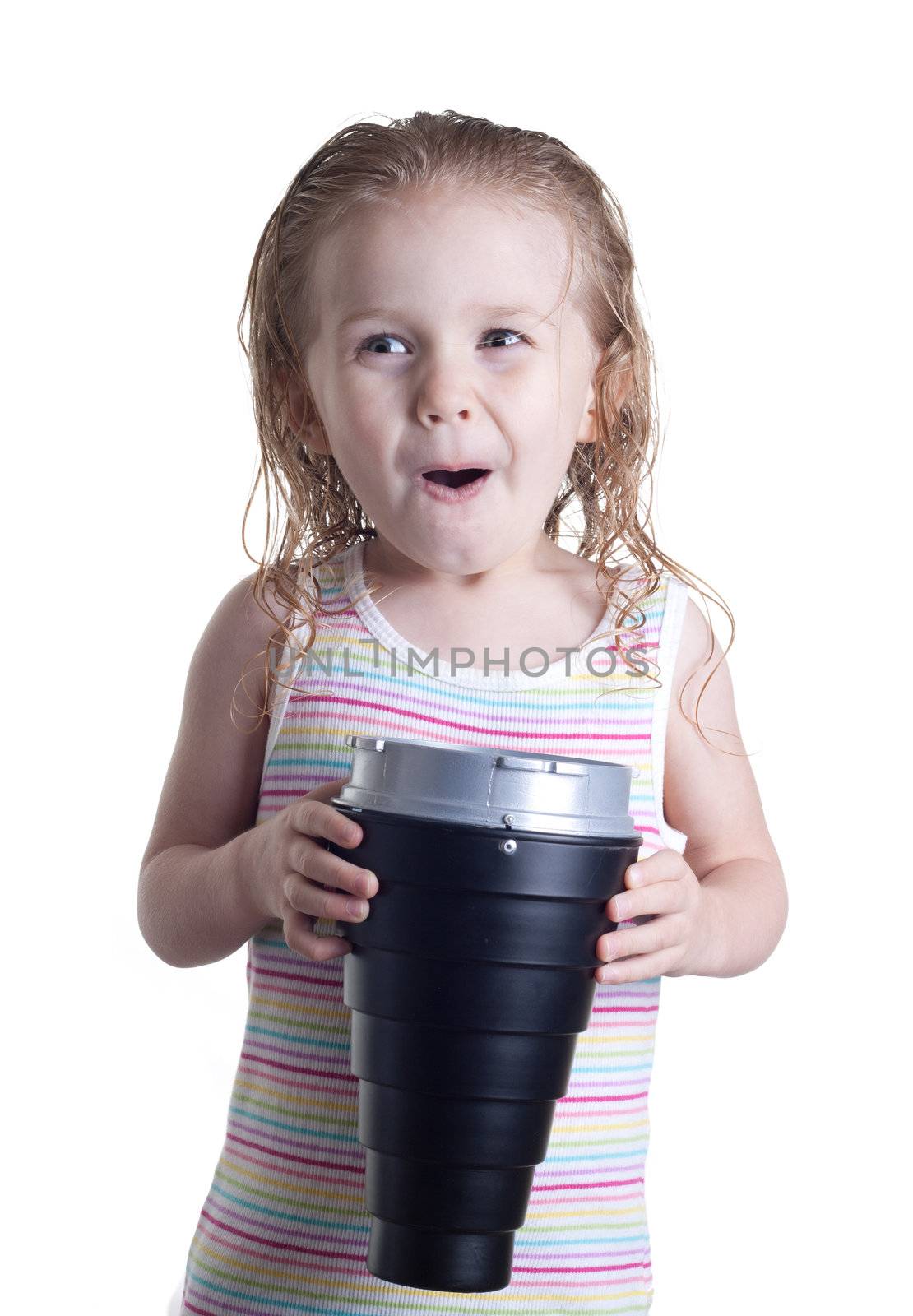 A girl is overjoyed by what is inside the cone she is holding.  The cone can be replaced by any object.