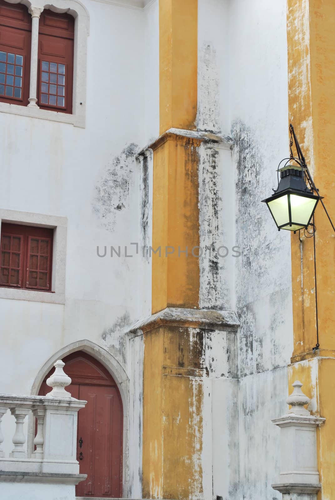 detail of a old church with a antique lamp