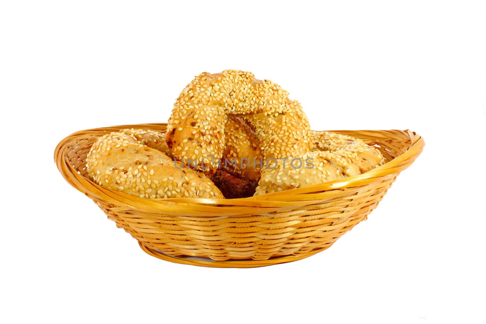 Smal rolls in a little woven basket isolated on white