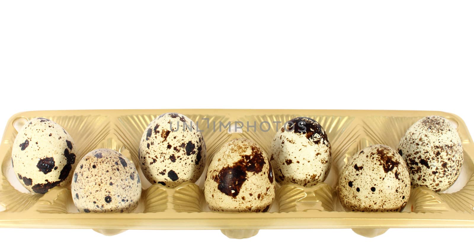 Eggs of japanese quail in little basket isolated on white