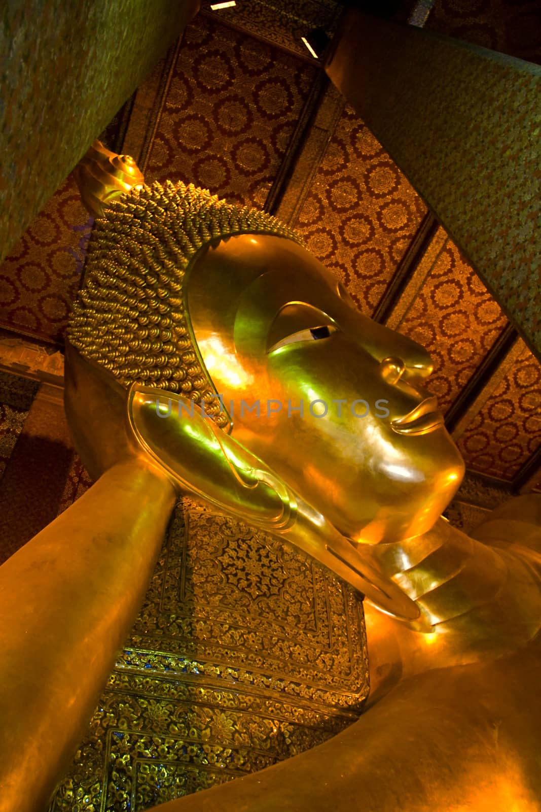 Reclining buddha within the Wat Pho in Bangkok Thailand by foryouinf