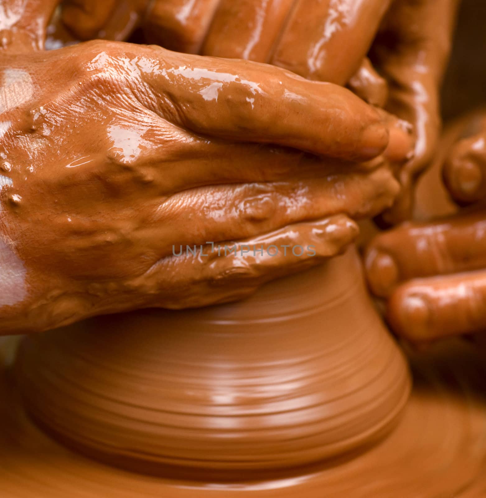 Potter shaping a bowl on a spinning wheel