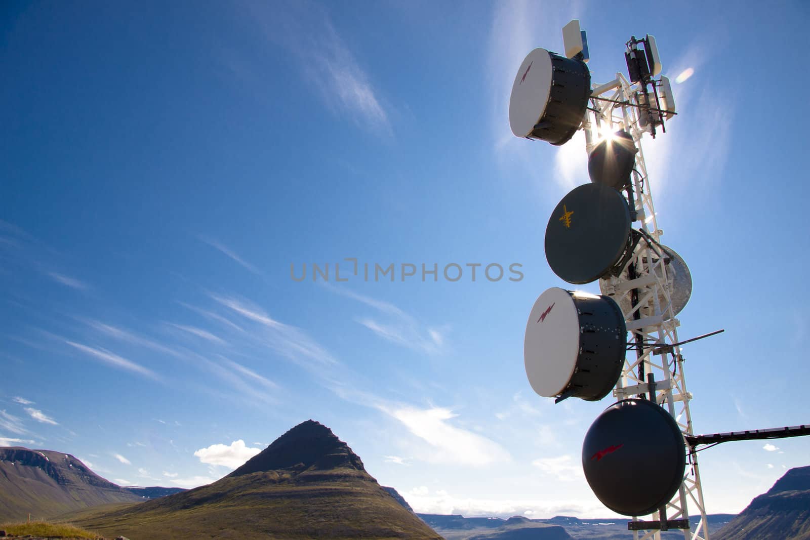 Iceland - cell antenas blue sky white clouds and sunlight