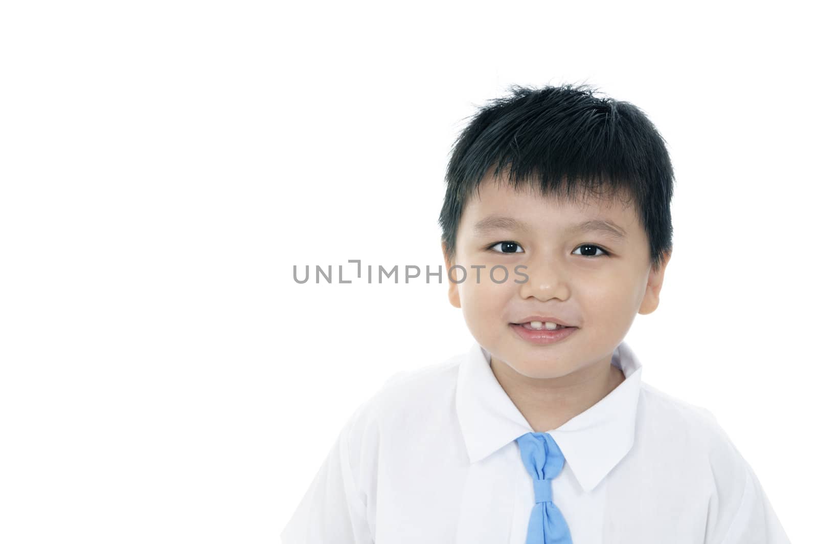 Portrait of a cheerful elementary schoolboy over white background.