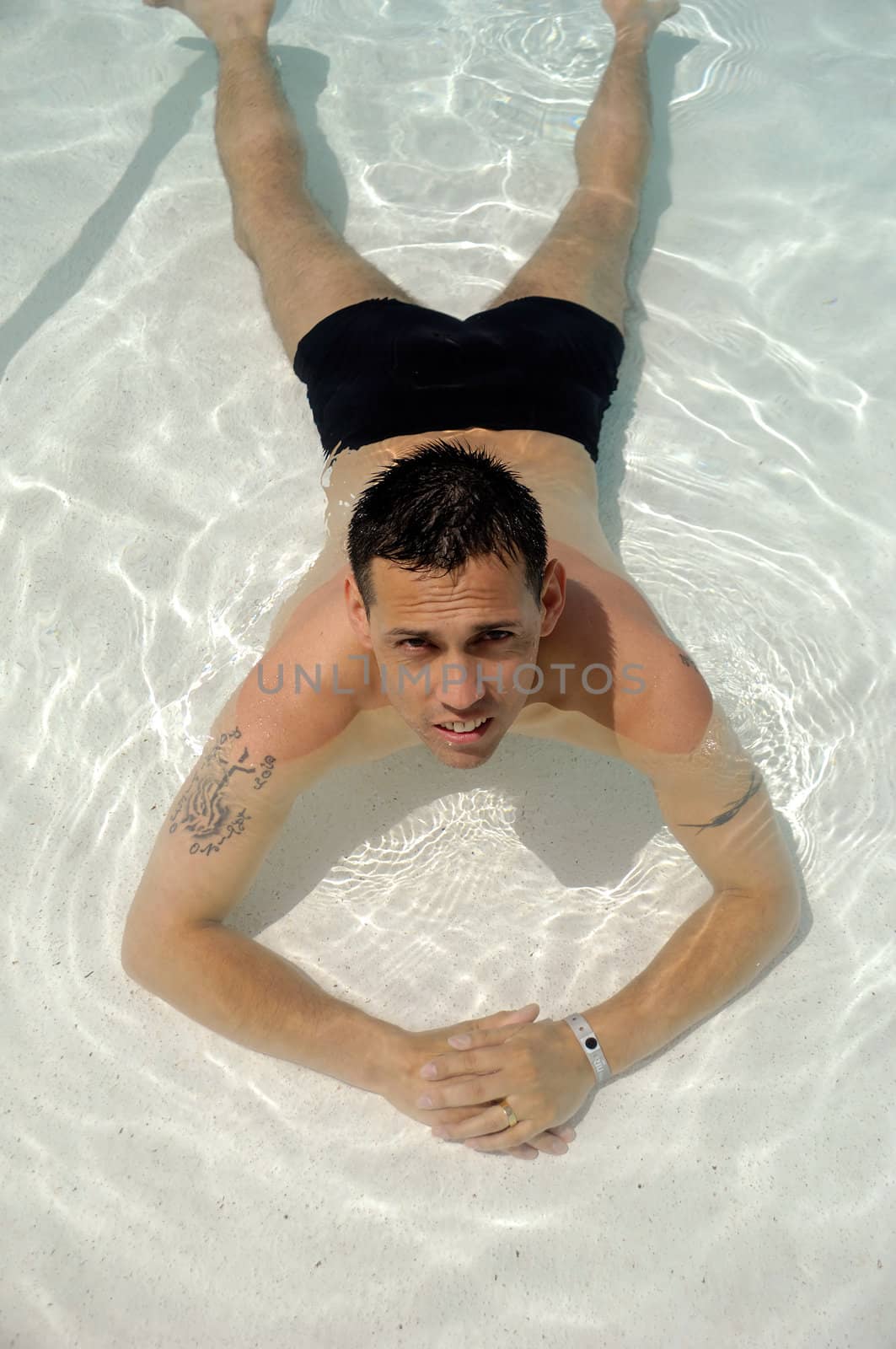 A man is relaxing in swimming pool