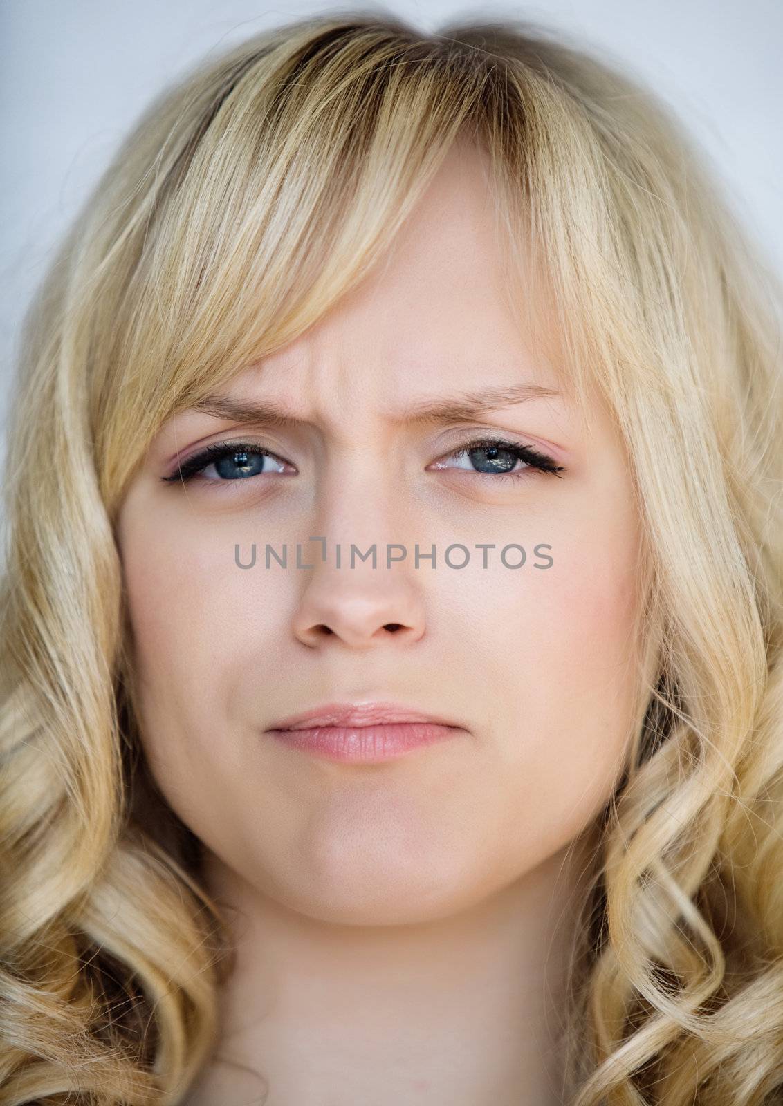 Portrait of the angry girl with light hair
