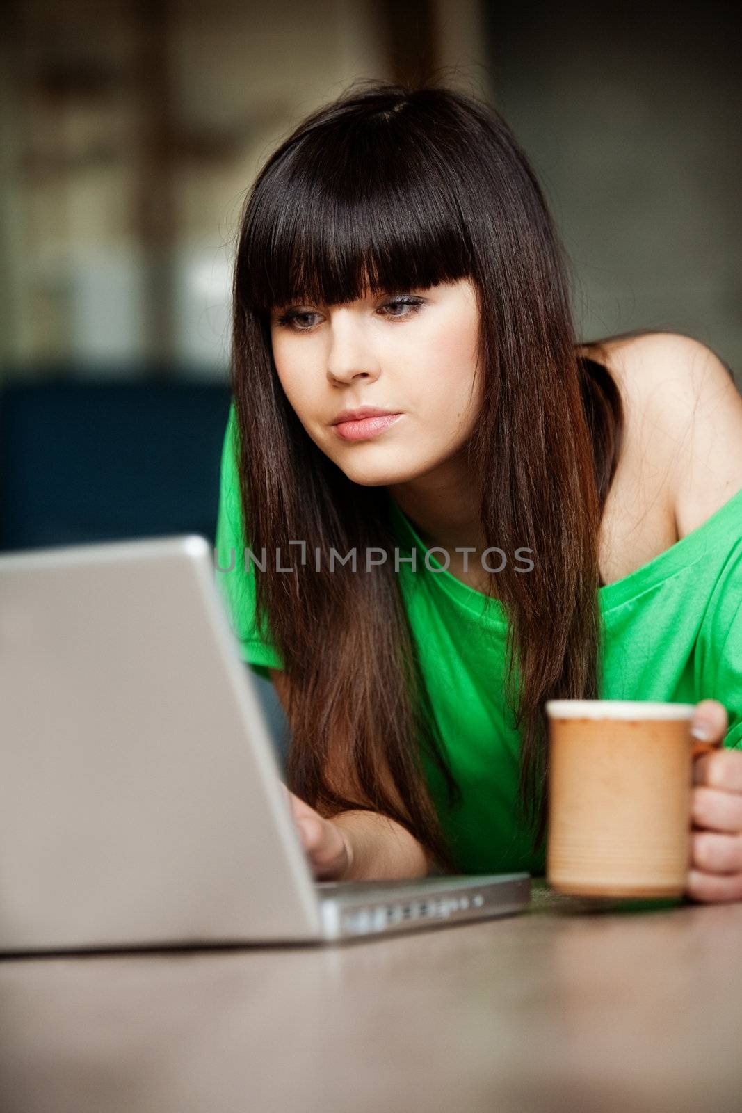 Girl with a cup near the computer by Gravicapa