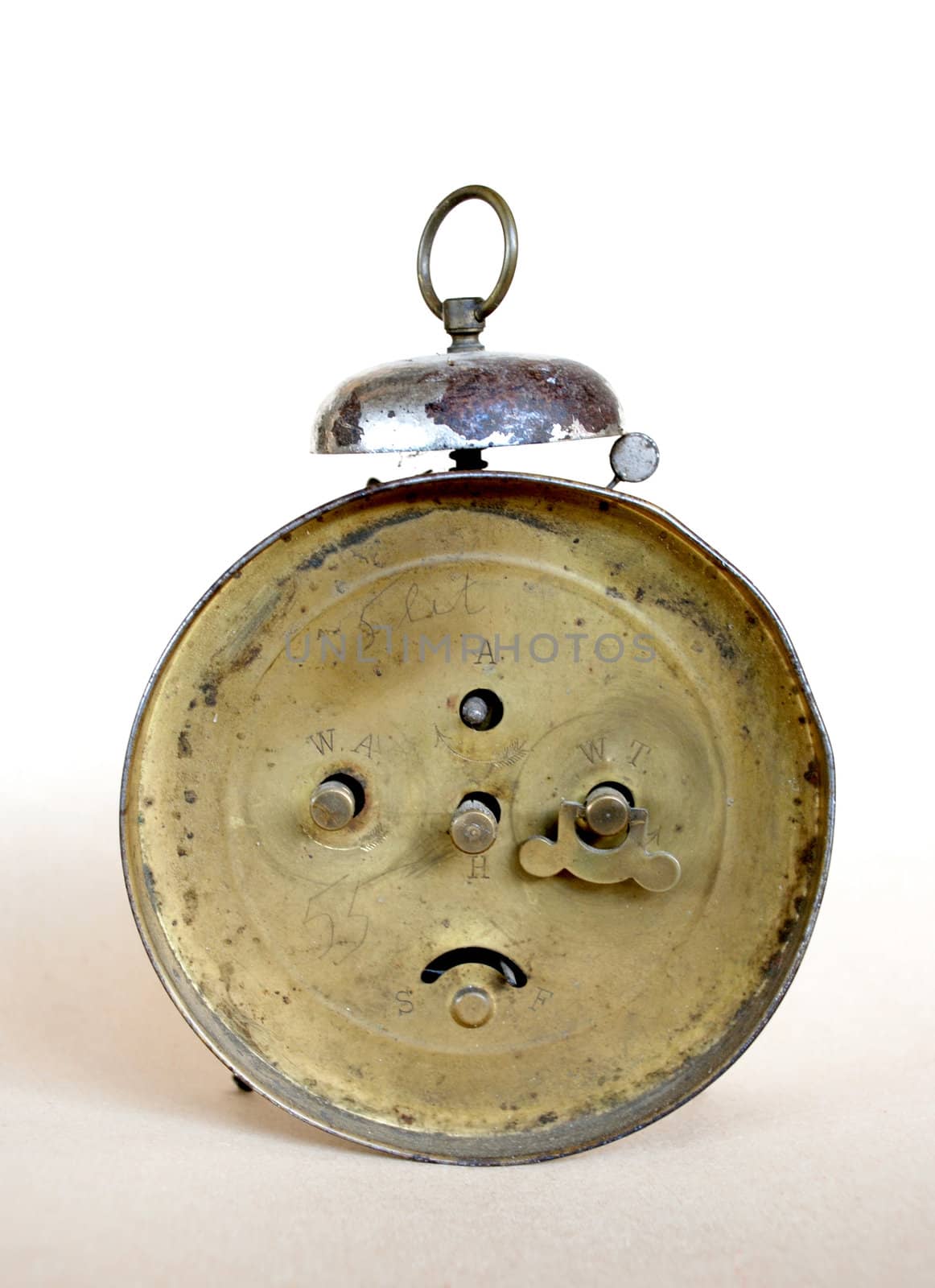 Brass widgets on old yellow alarm clock.