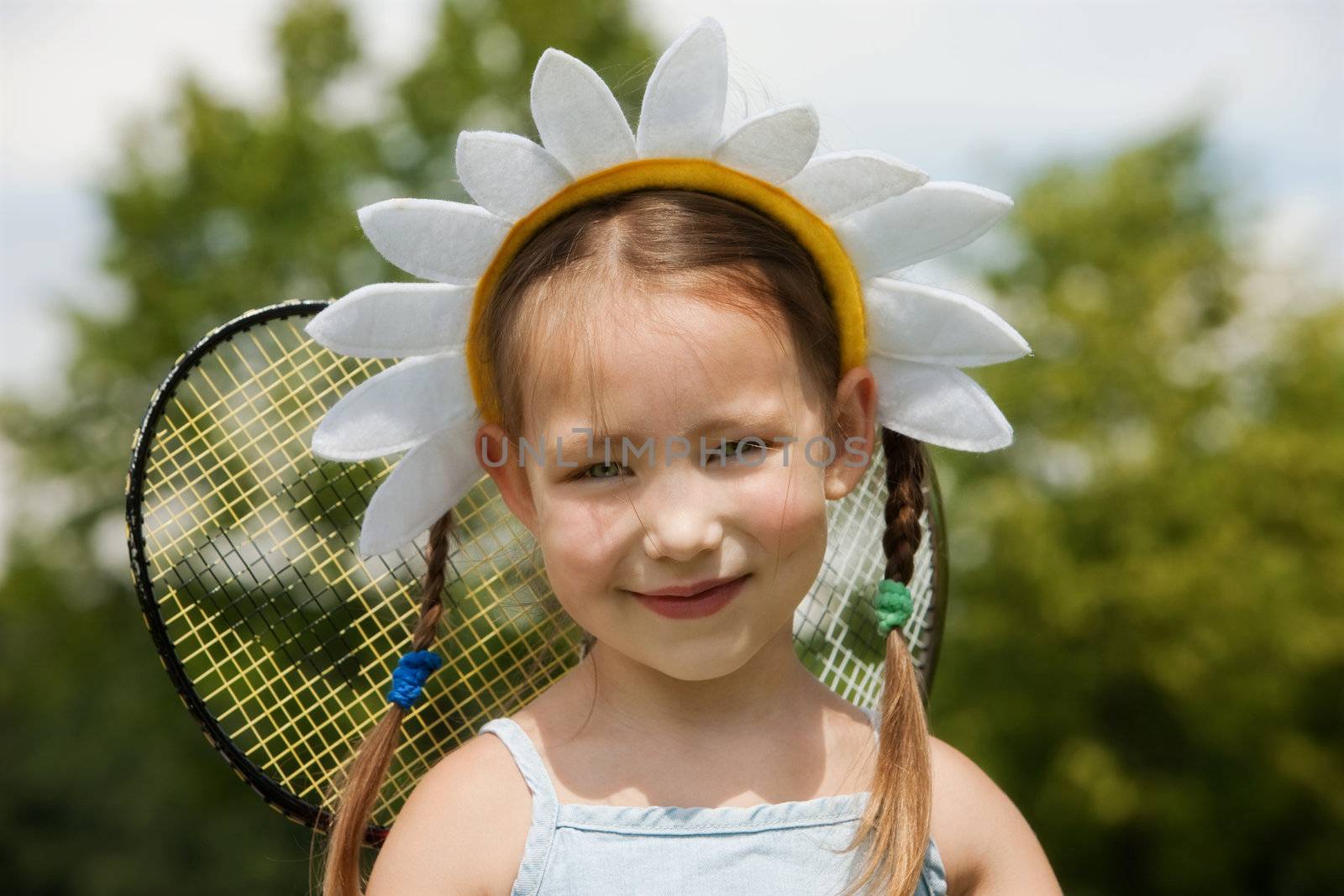 Portrait of little girl in camomile hat 
