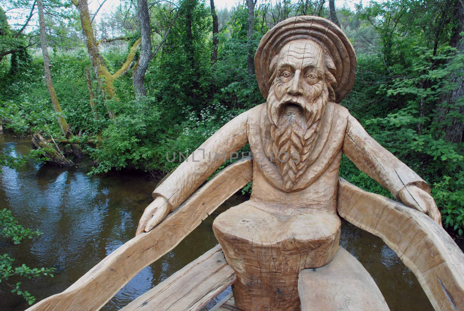 Decorative bench - a sculpture carved from a tree at the river resort