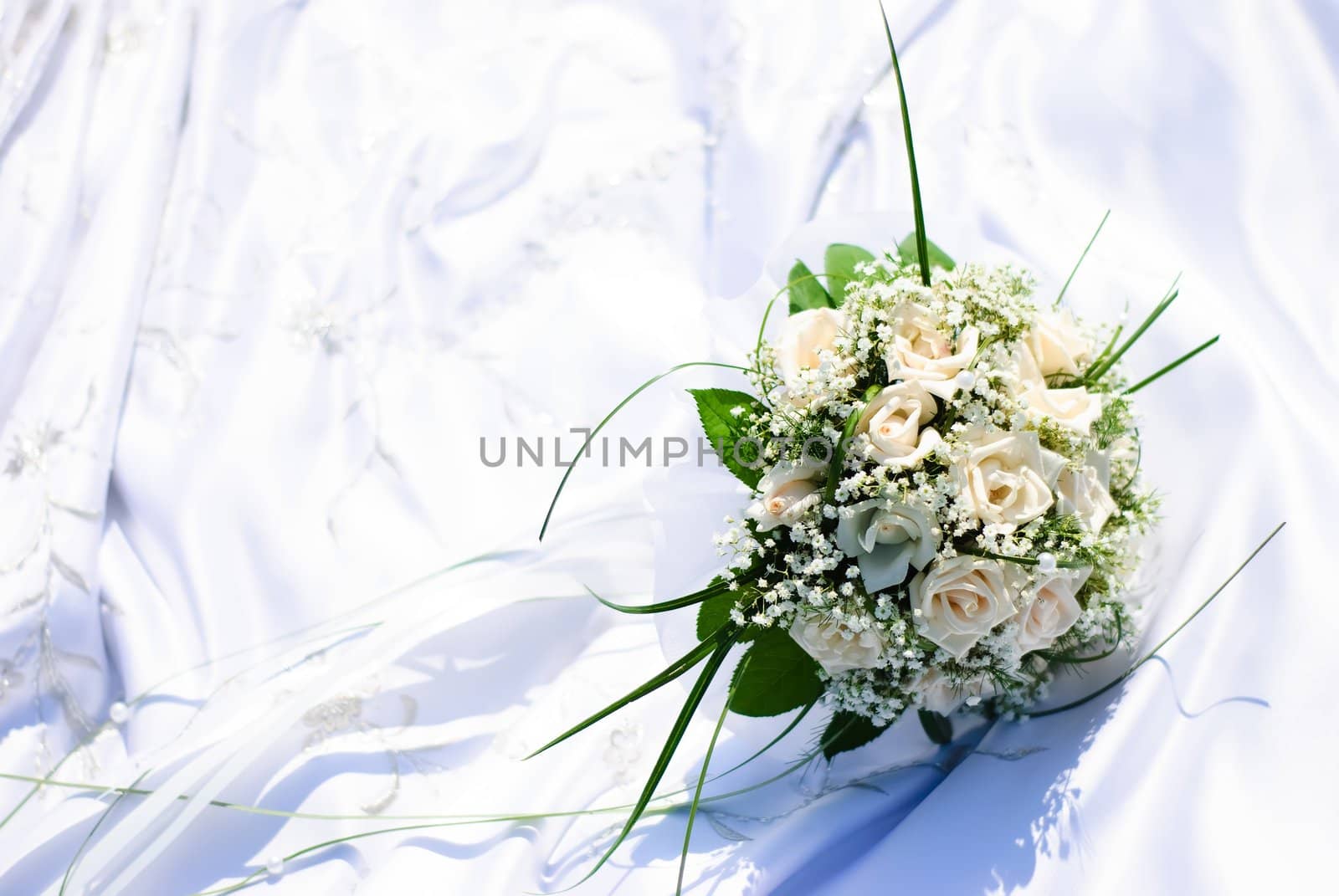 bridal bouquet of white roses on a wedding dress