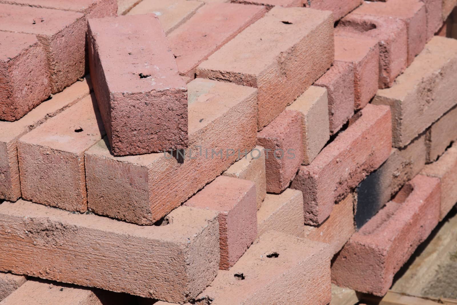 A pile of red bricks at a construction site.