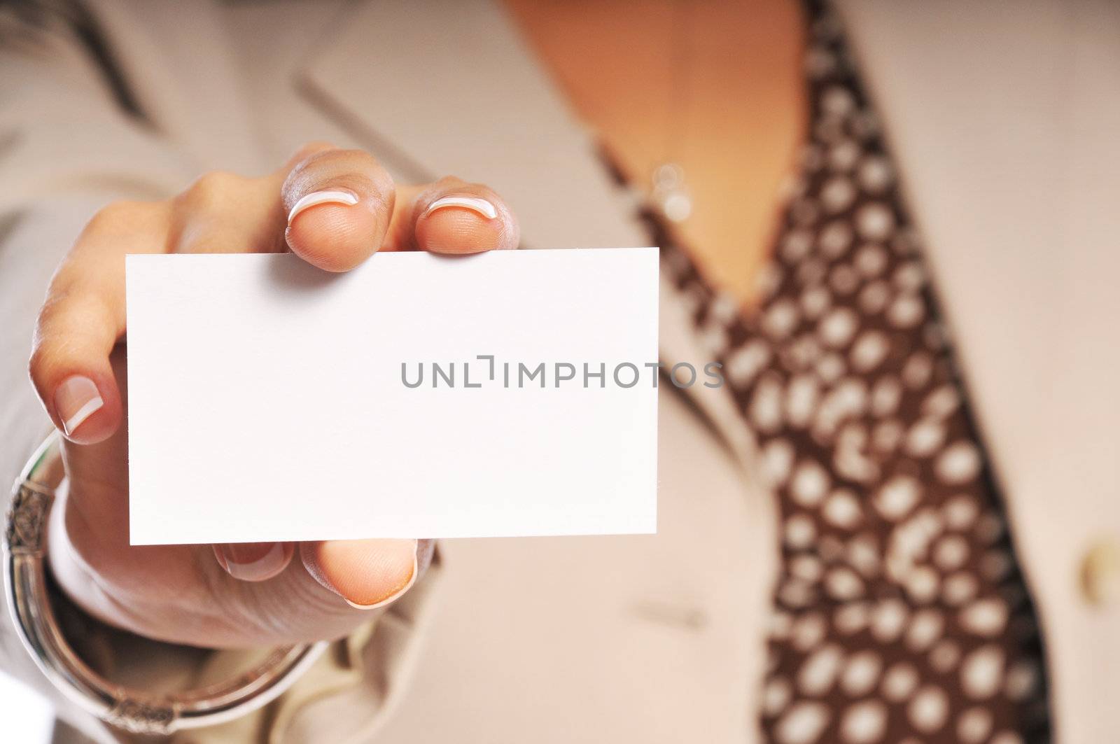 woman showing her business card with focus on the card.