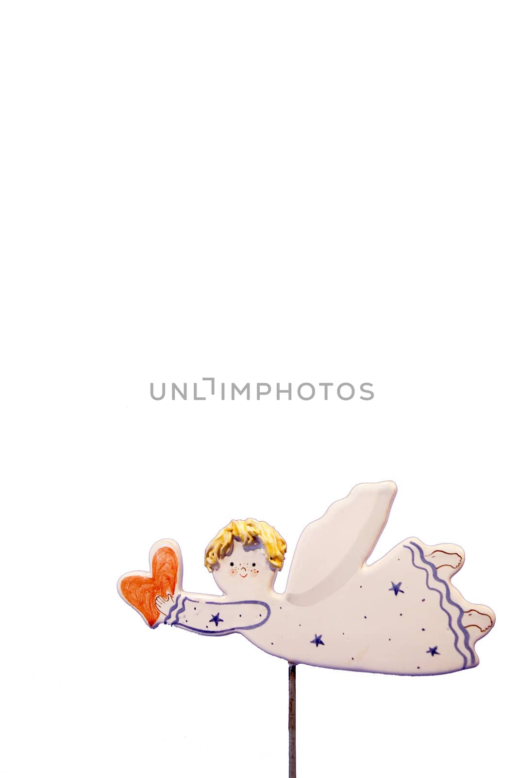 Ceramic angel holding a heart piece isolated on a white background