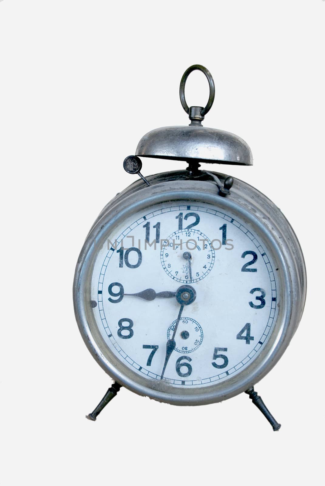 Silver old mechanical alarm clock on a white background