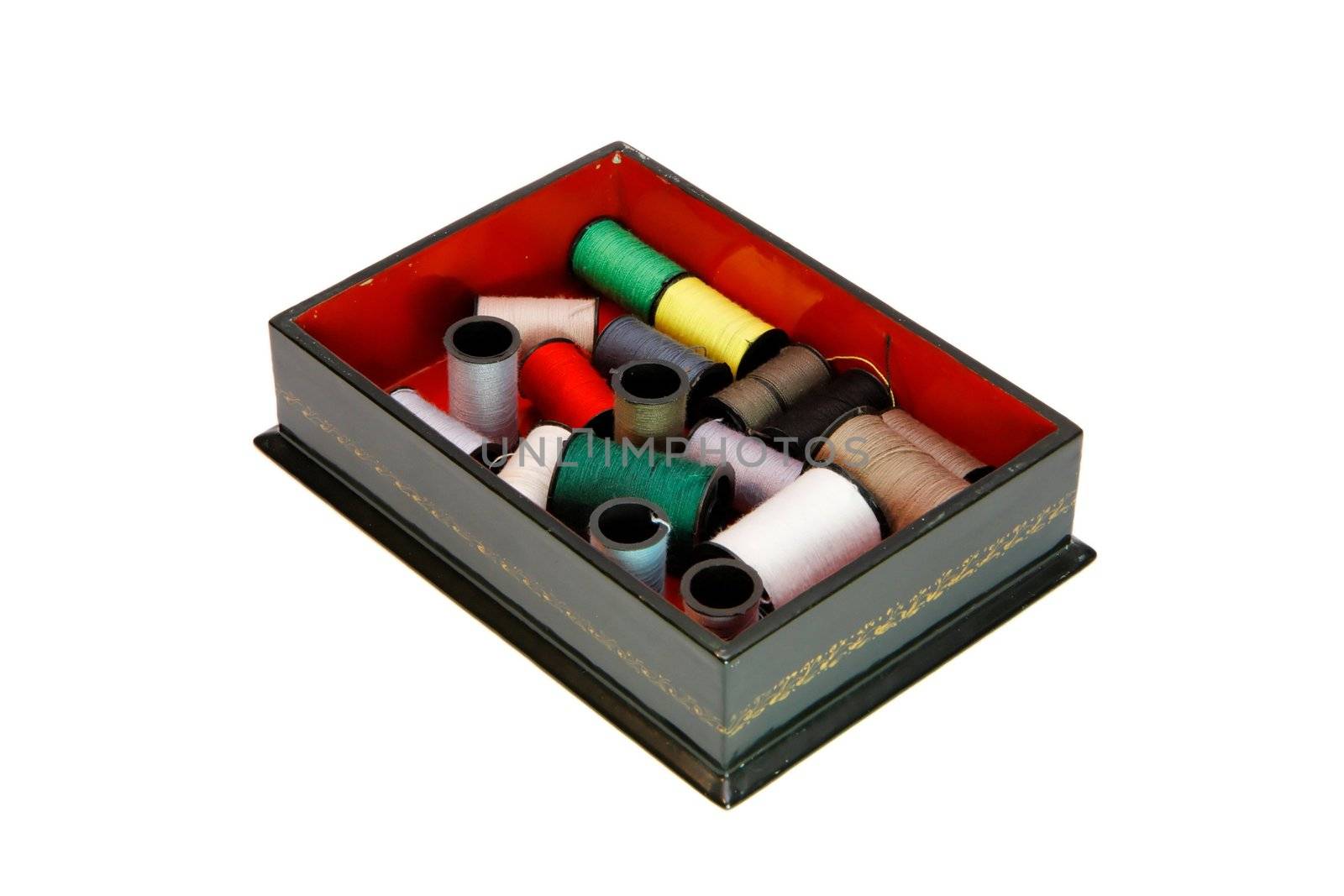 Dark green wooden casket with colorful threads isolated