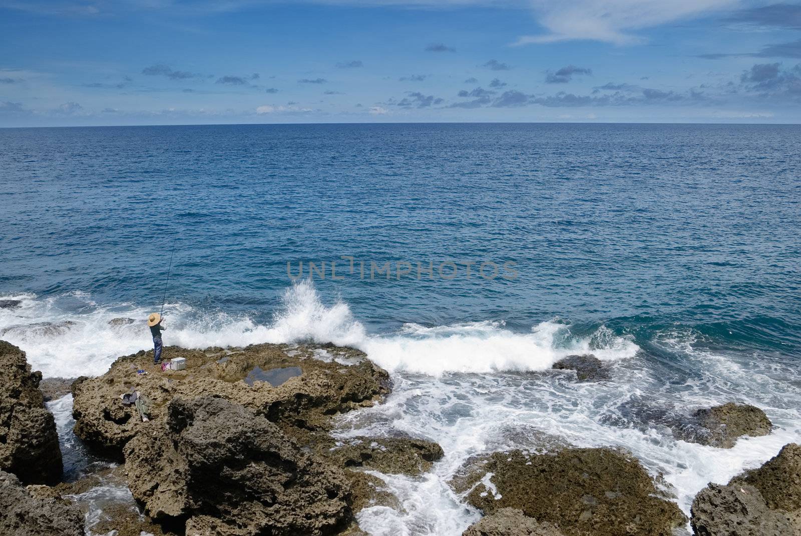 It is a beautiful coral reef rock coastline with blue sky in kenting of Taiwan.