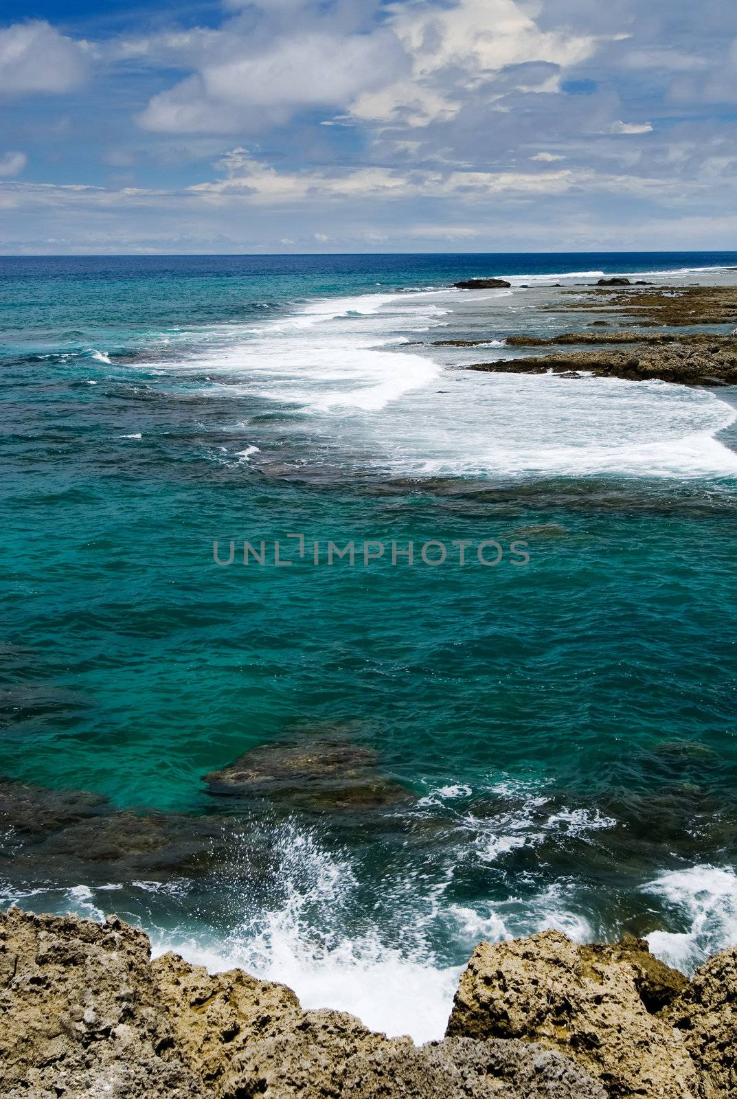 It is a beautiful coral reef rock cape with blue sky in kenting of Taiwan.