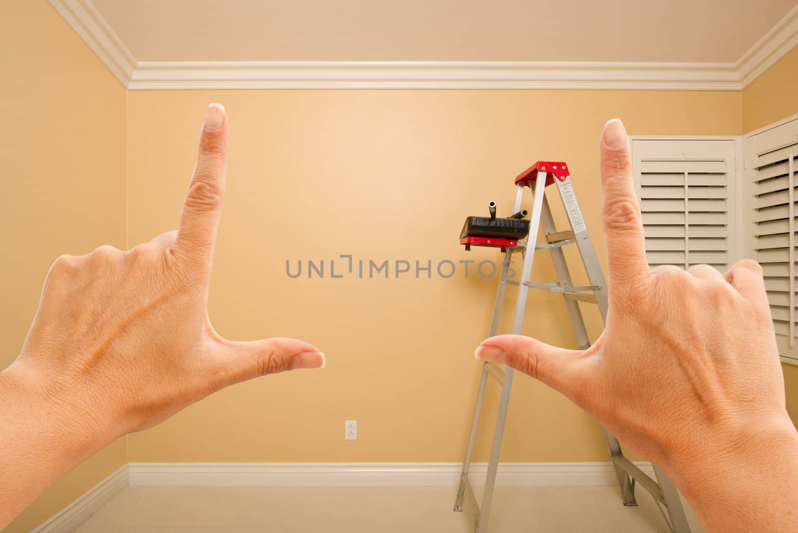 Female Hands Framing Beautiful Room Interior Imagining What to Do with the Room.