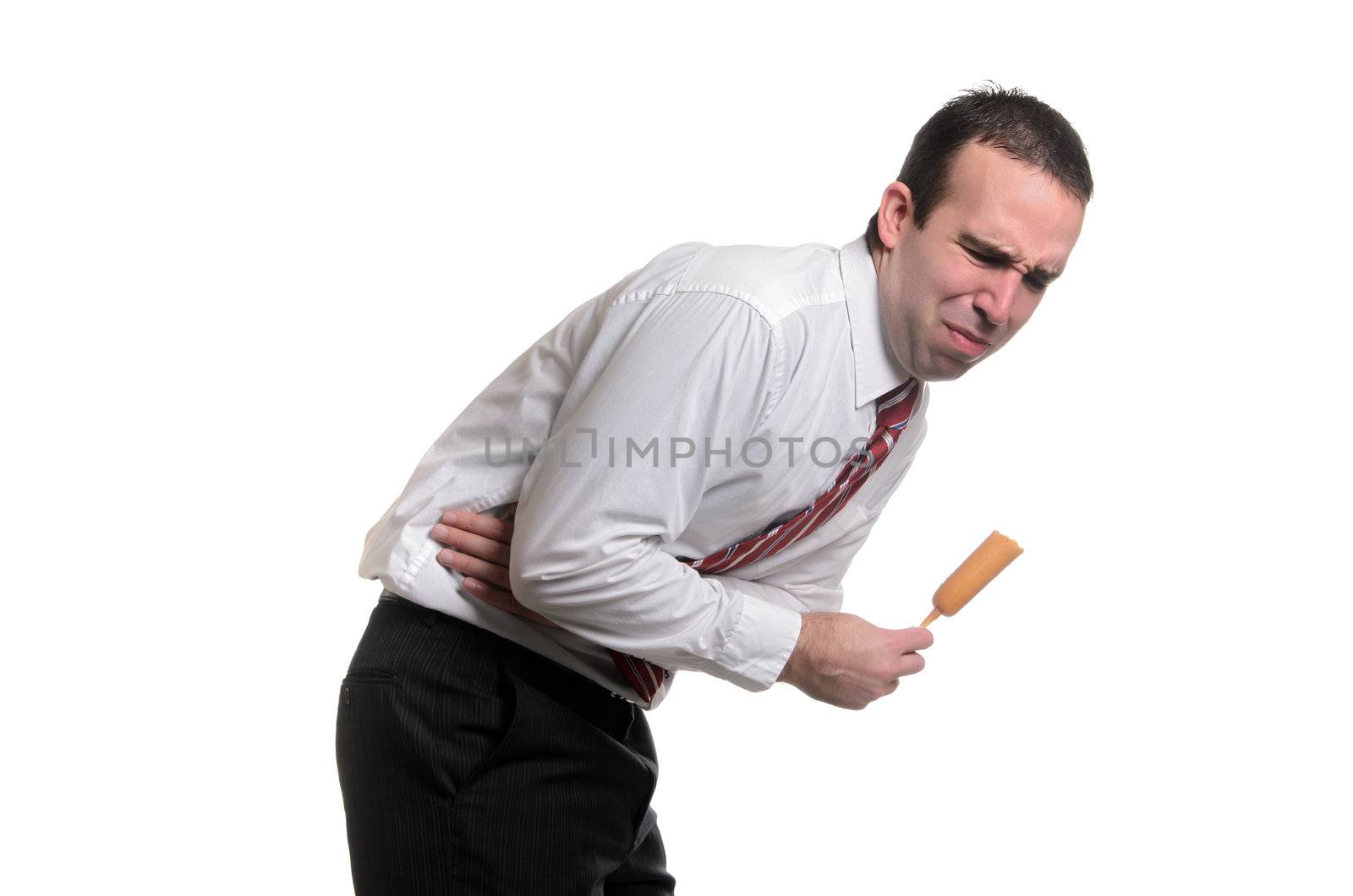 A young man suffering from food poisoning from eating a bad corn dog, isolated against a white background.