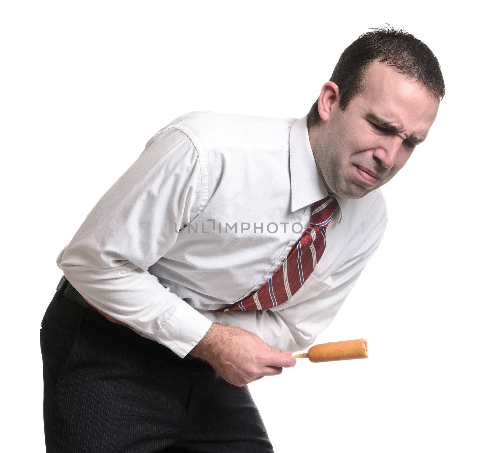 A young man suffering from a stomach ache due to eating a bad corn dog. Isolated against a white background.