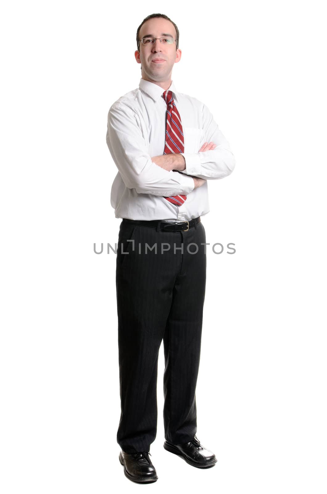 A young businessman standing with his arms crossed, isolated on a white background