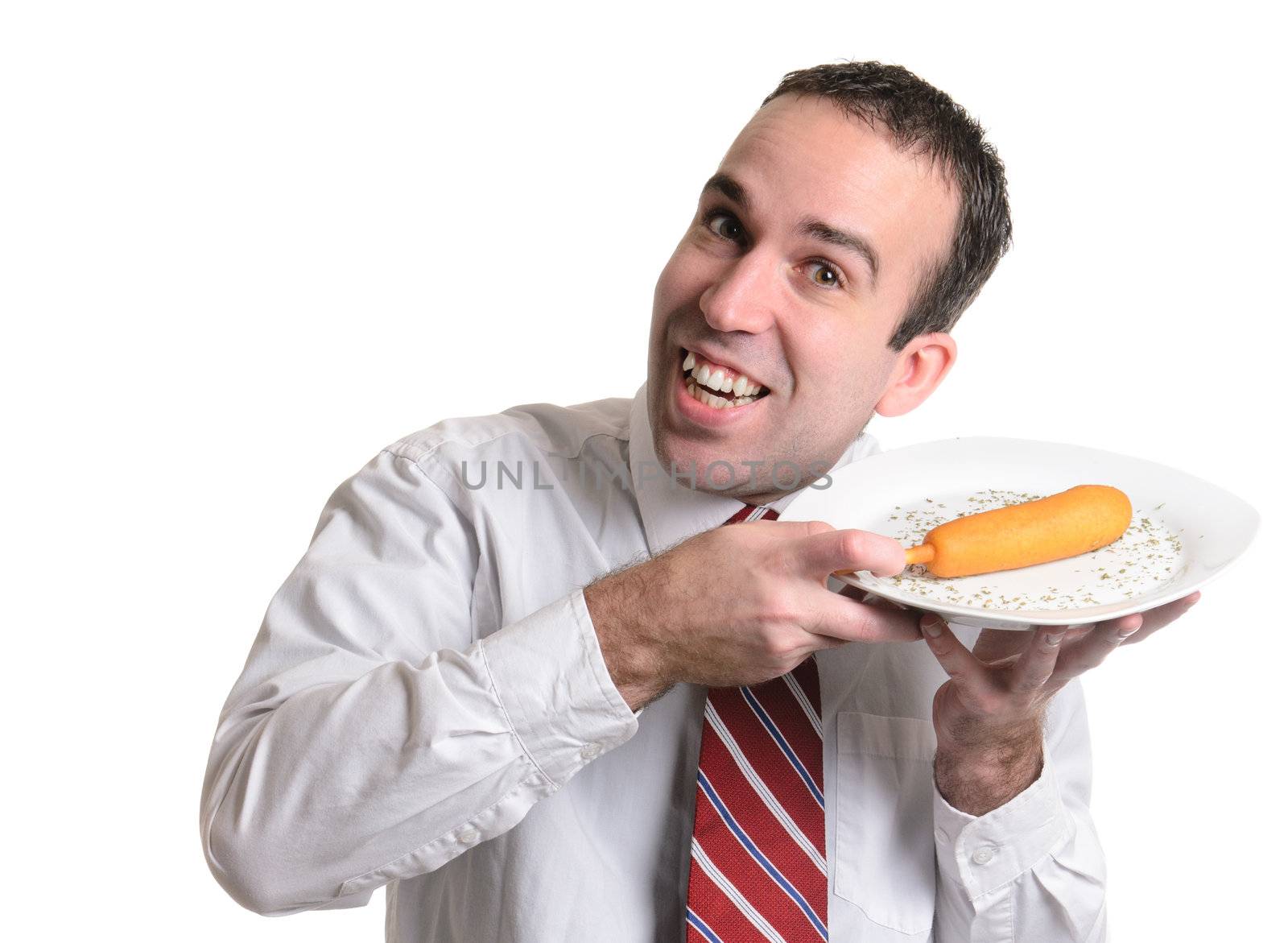 A happy young man is displaying his corn dog isolated against a white background.