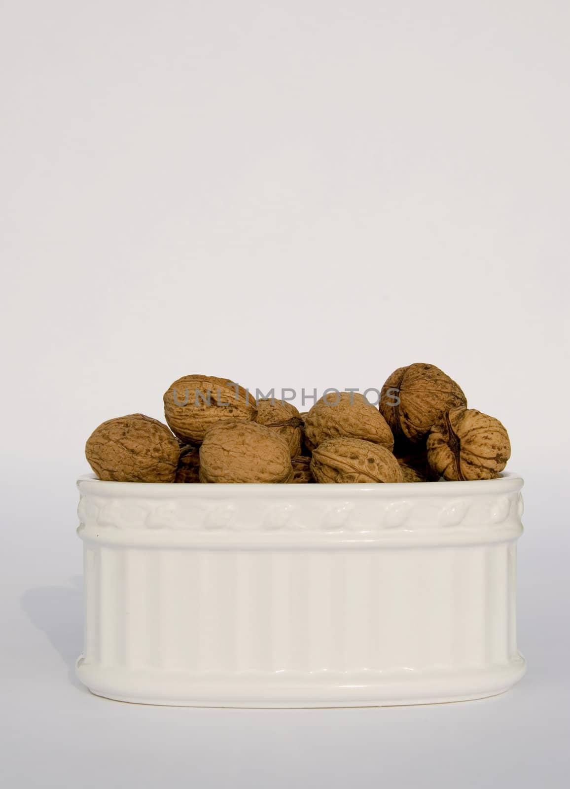 Box of different sizes walnuts isolated on a white background