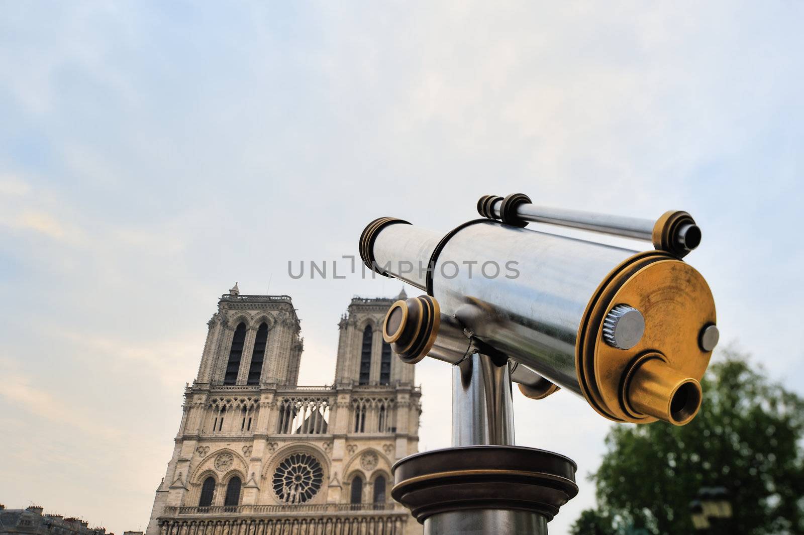 Telescope of stainless steel on against facade Notre-Dame