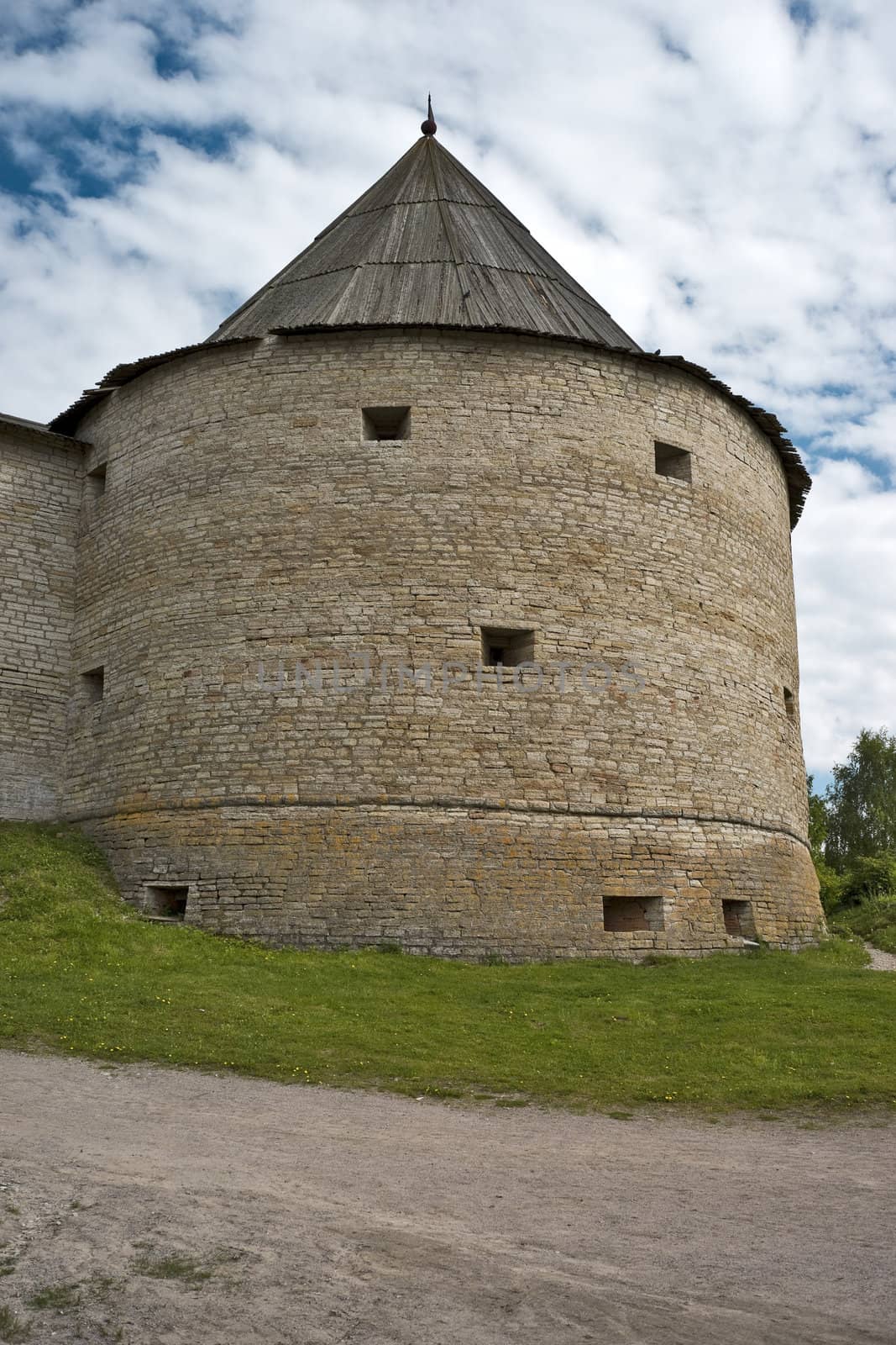 Fortress tower with portholes and conic roof