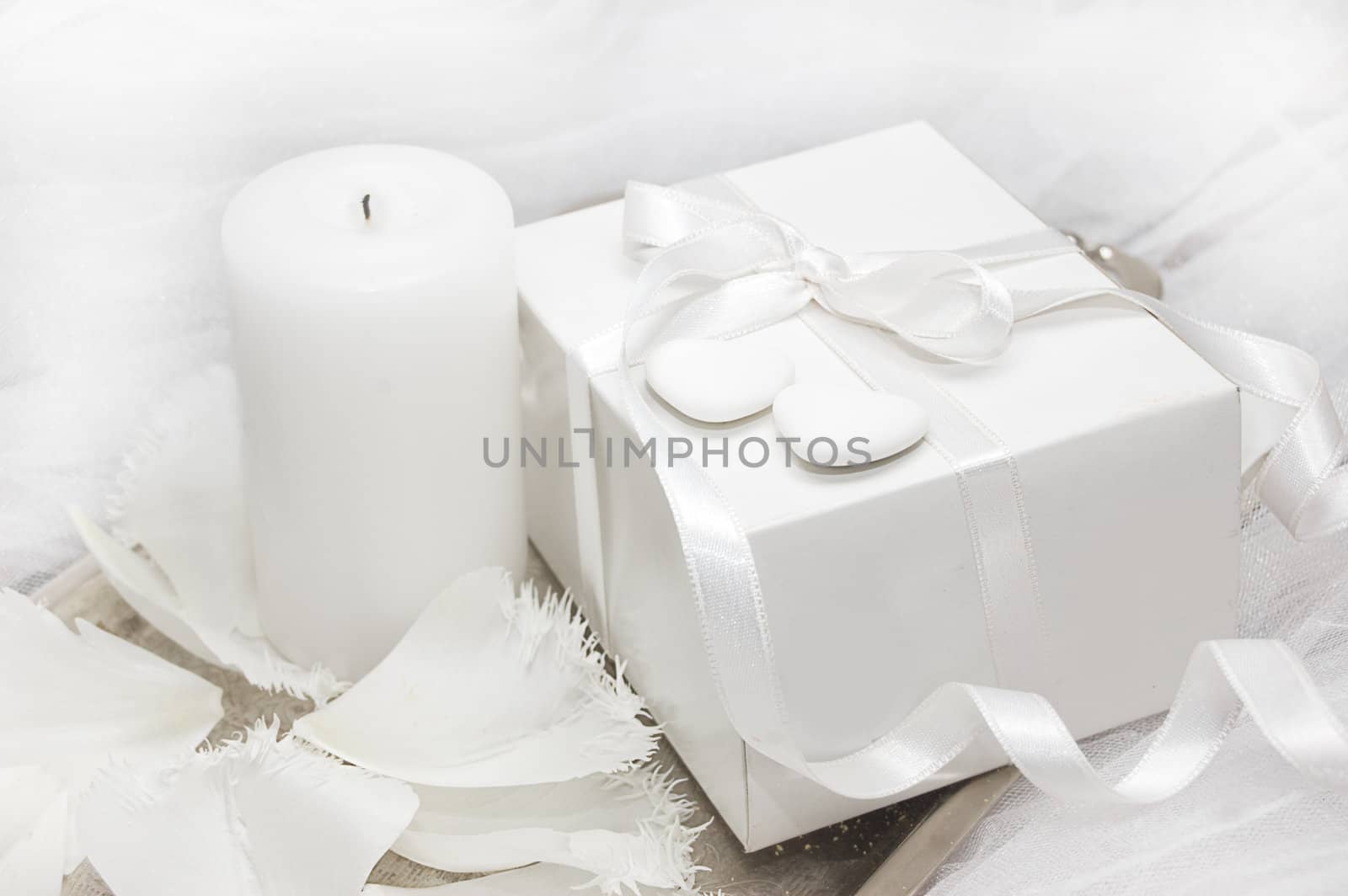 White gift box with candle and tulip