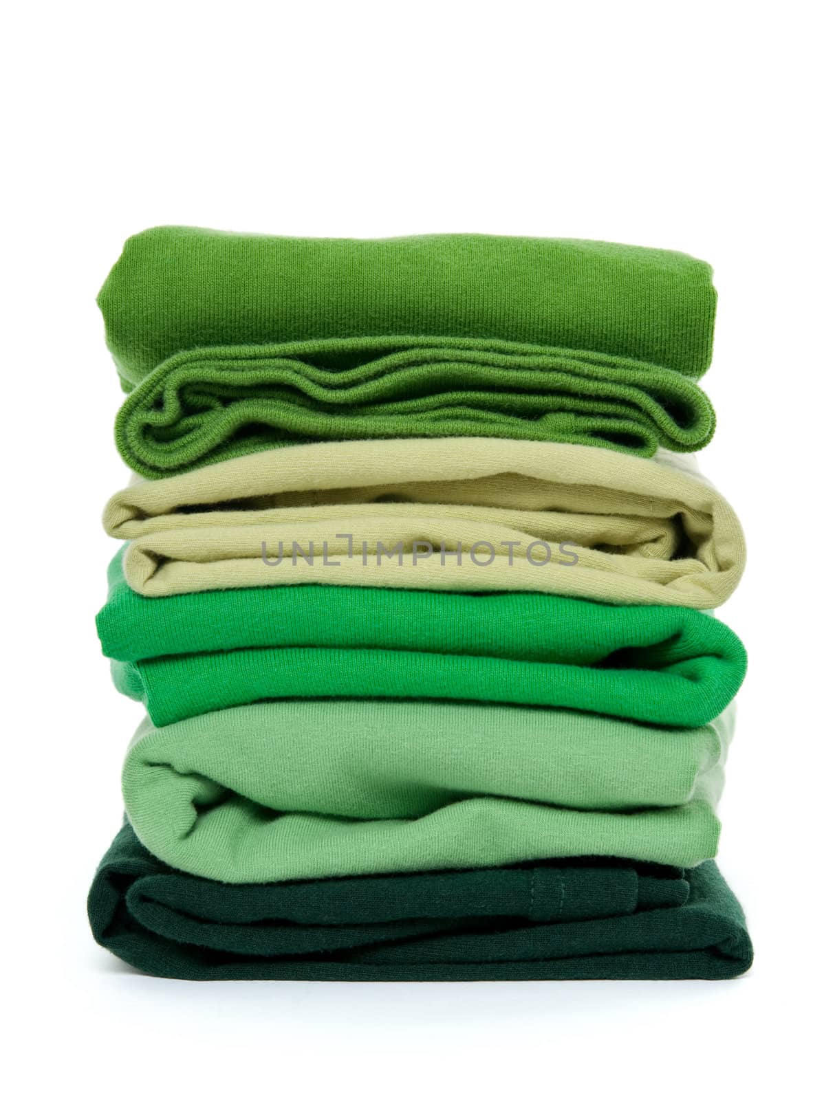 Laundry - pile of green folded clothes on white background.
