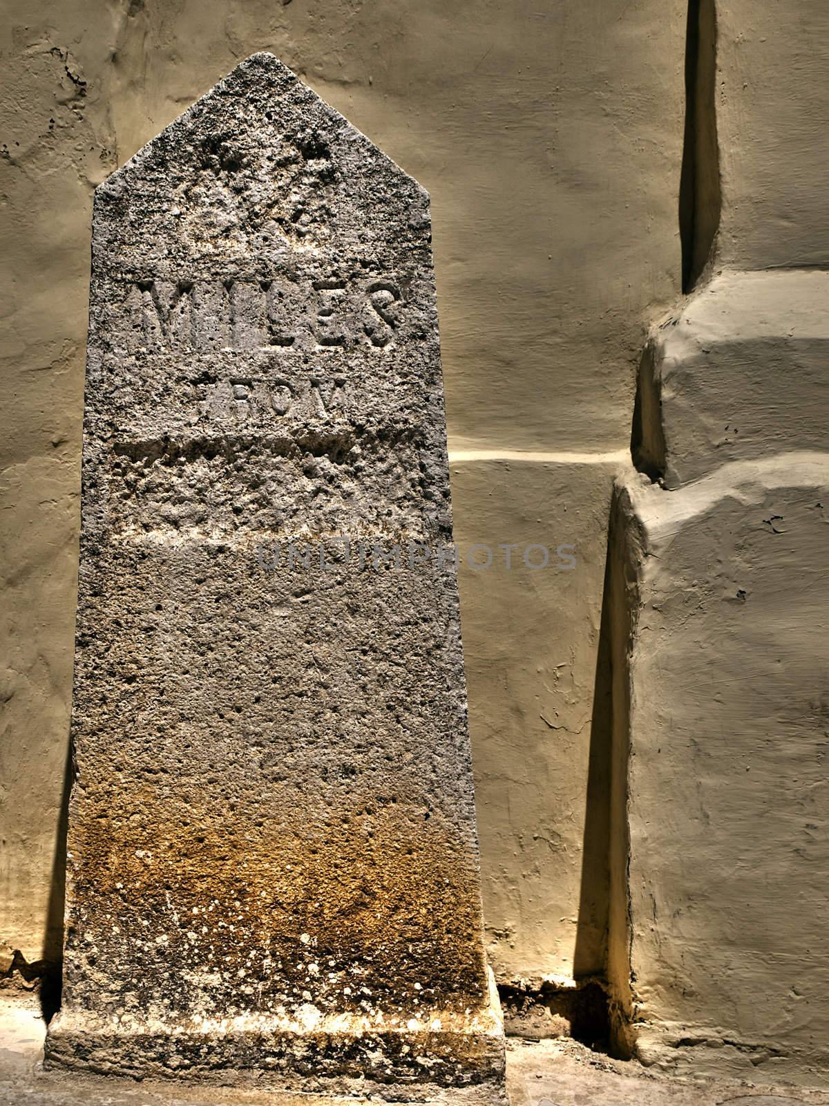 HDR image of old British milestone in Malta defaced during WWII 
