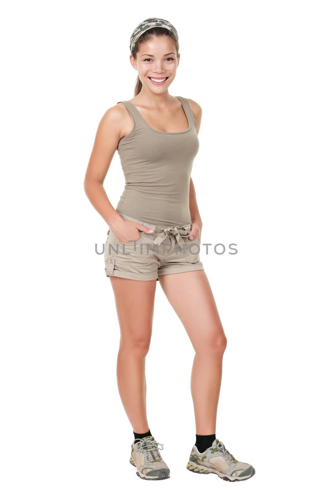 Hiking sporty sexy woman hiker isolated on white background standing in full length. Mixed race female Asian / Caucasian model in summer walking outfit and shoes.