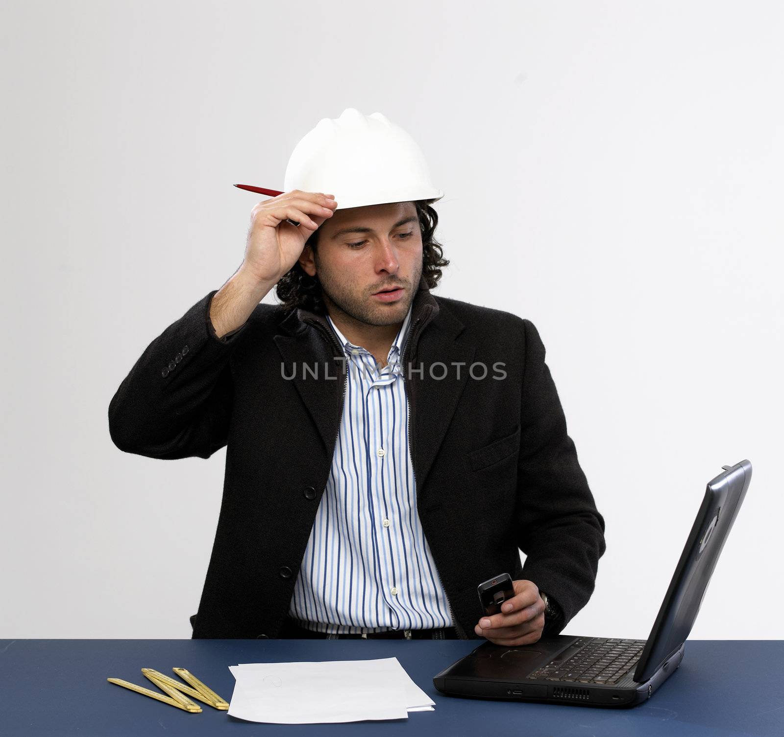 Young architect at work with laptop isolated