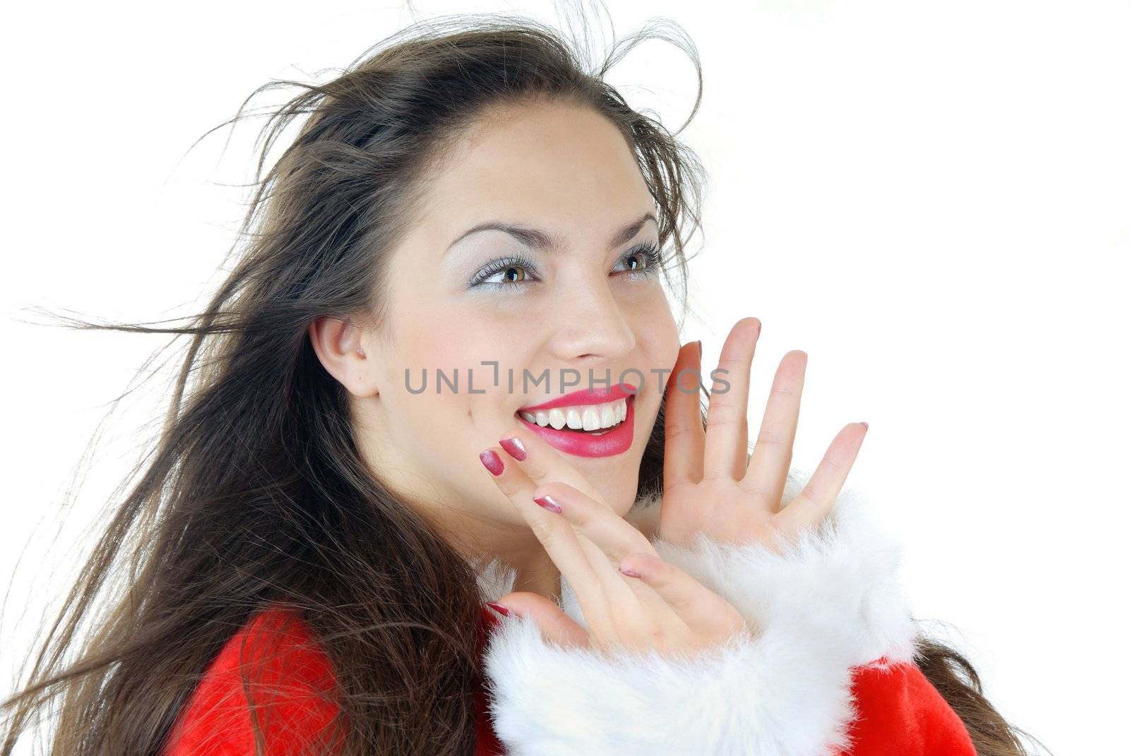 Smiling happy lady with blown hairs in a furry Santa Claus dress on a white background