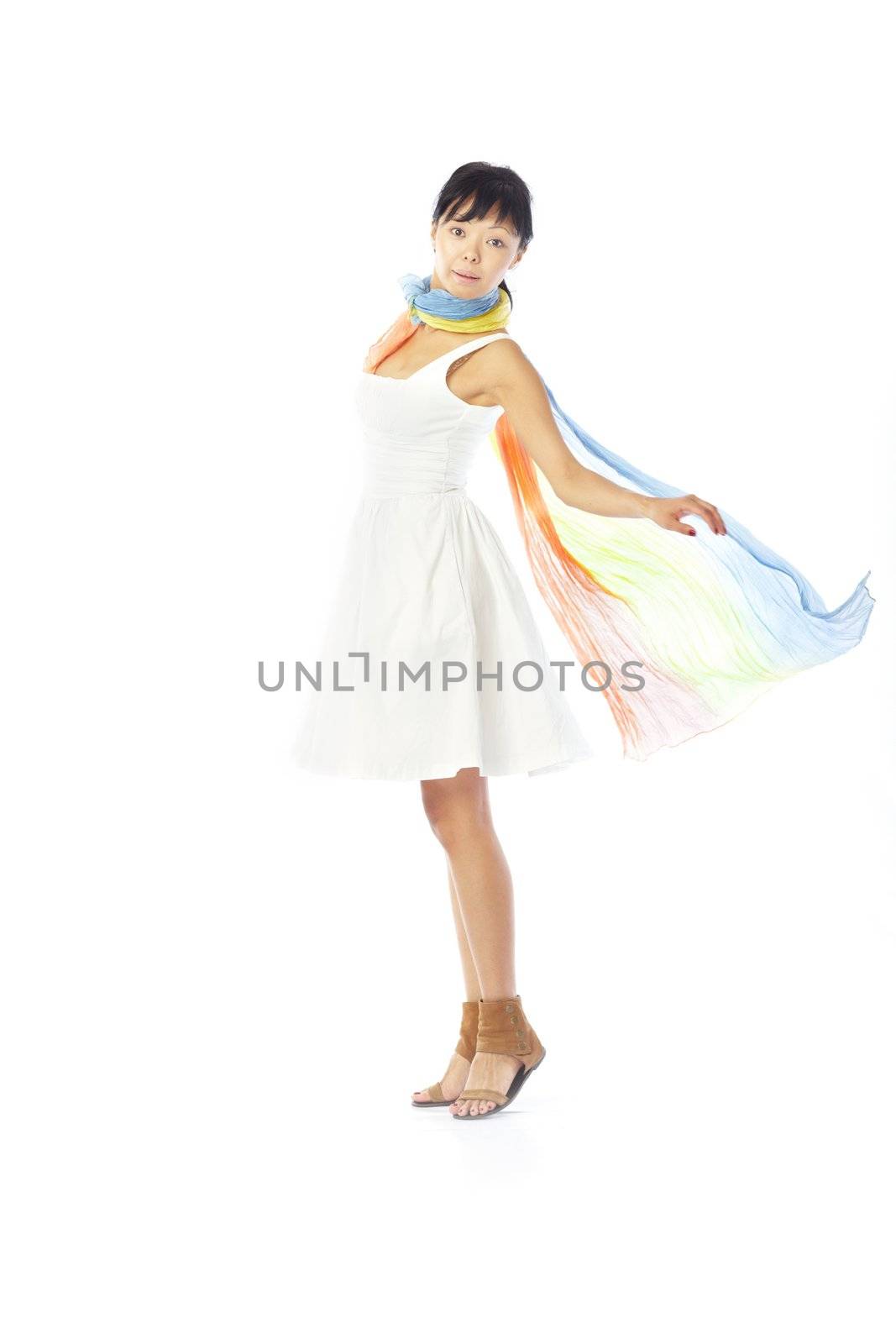 Elegant lady in the stylish dress and scarf dancing on a white background