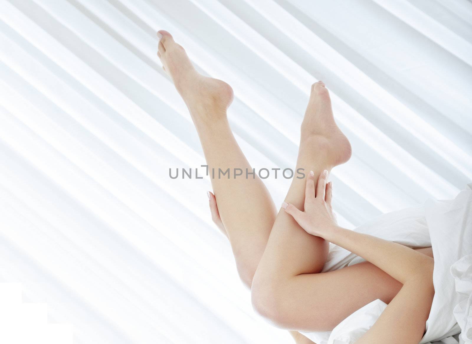 Shoeless of the woman laying on the bed in the bedroom. Close-up photo