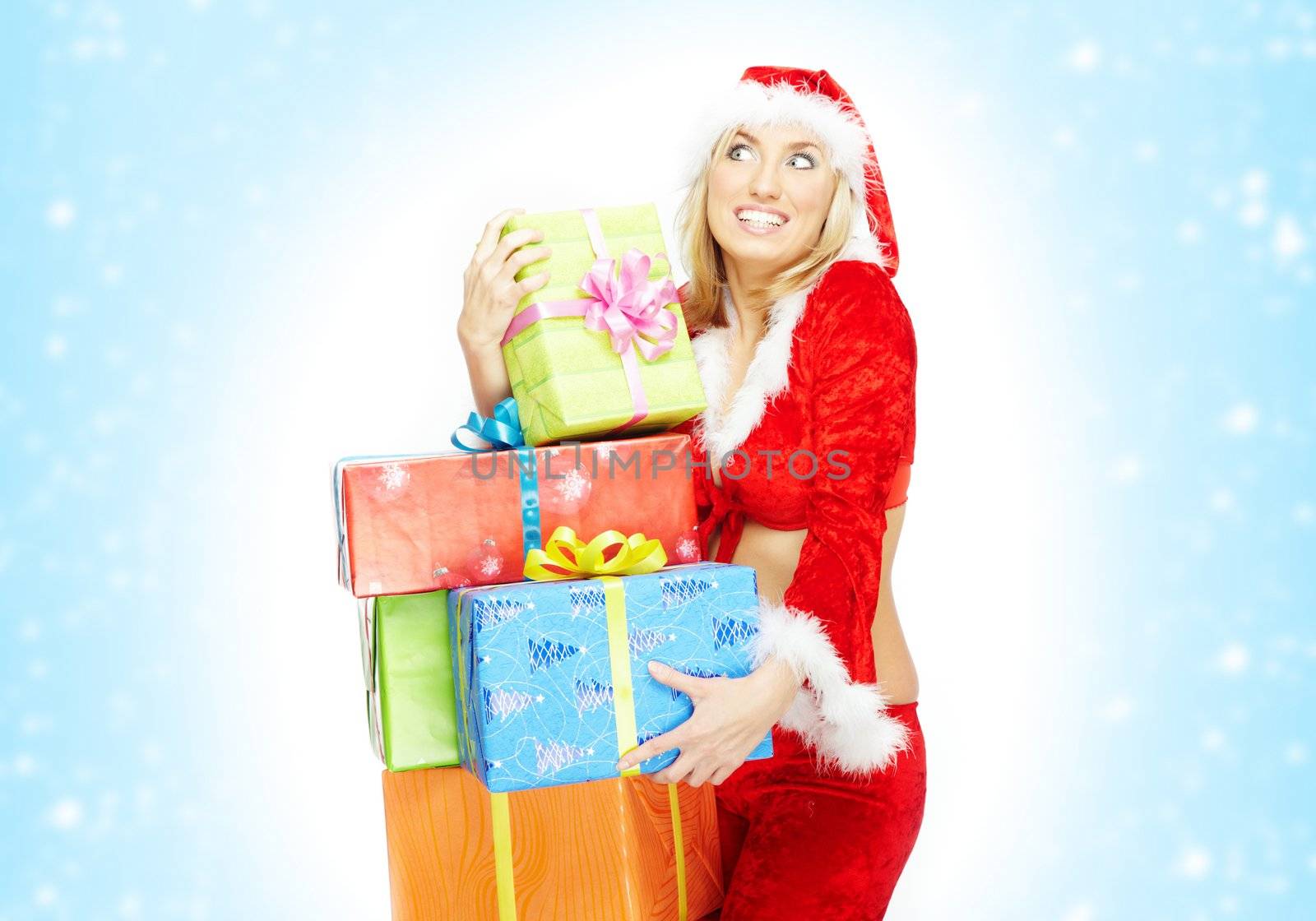 Happy lady in the red Santa Claus costume holding gift boxes on a white and blue background with snow