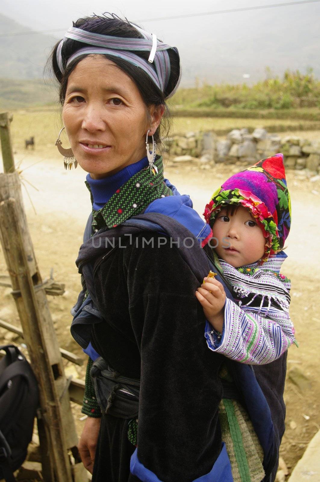 The Hmong live in small community of some houses. Hmong women have the best clothes of all minorities in Vietnam in general. Their traditional dress is two colors. Blue and black is essential. They have this particular hairstyle that ties their hair with a large blue ribbon. The silver earrings are a must.