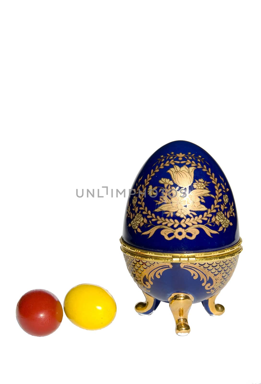 Colored Easter eggs near Faberge egg copy isolated on a white background