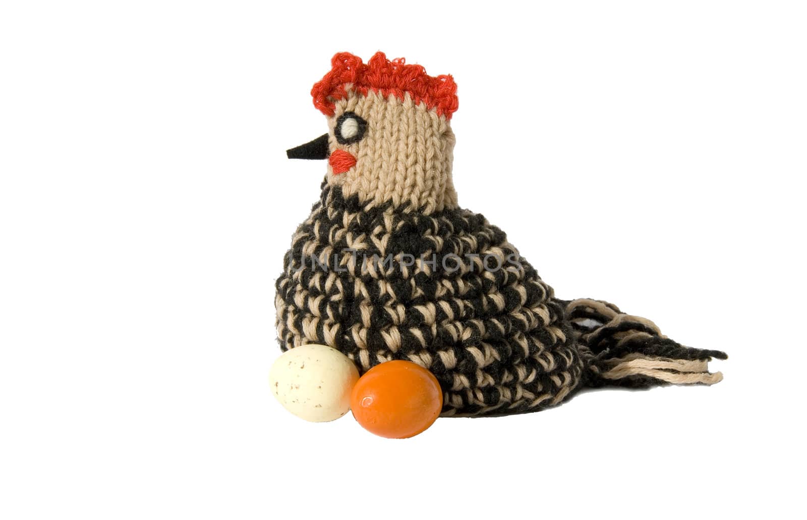 Easter chicken knitted from woollen thread and two eggs isolated on a white background