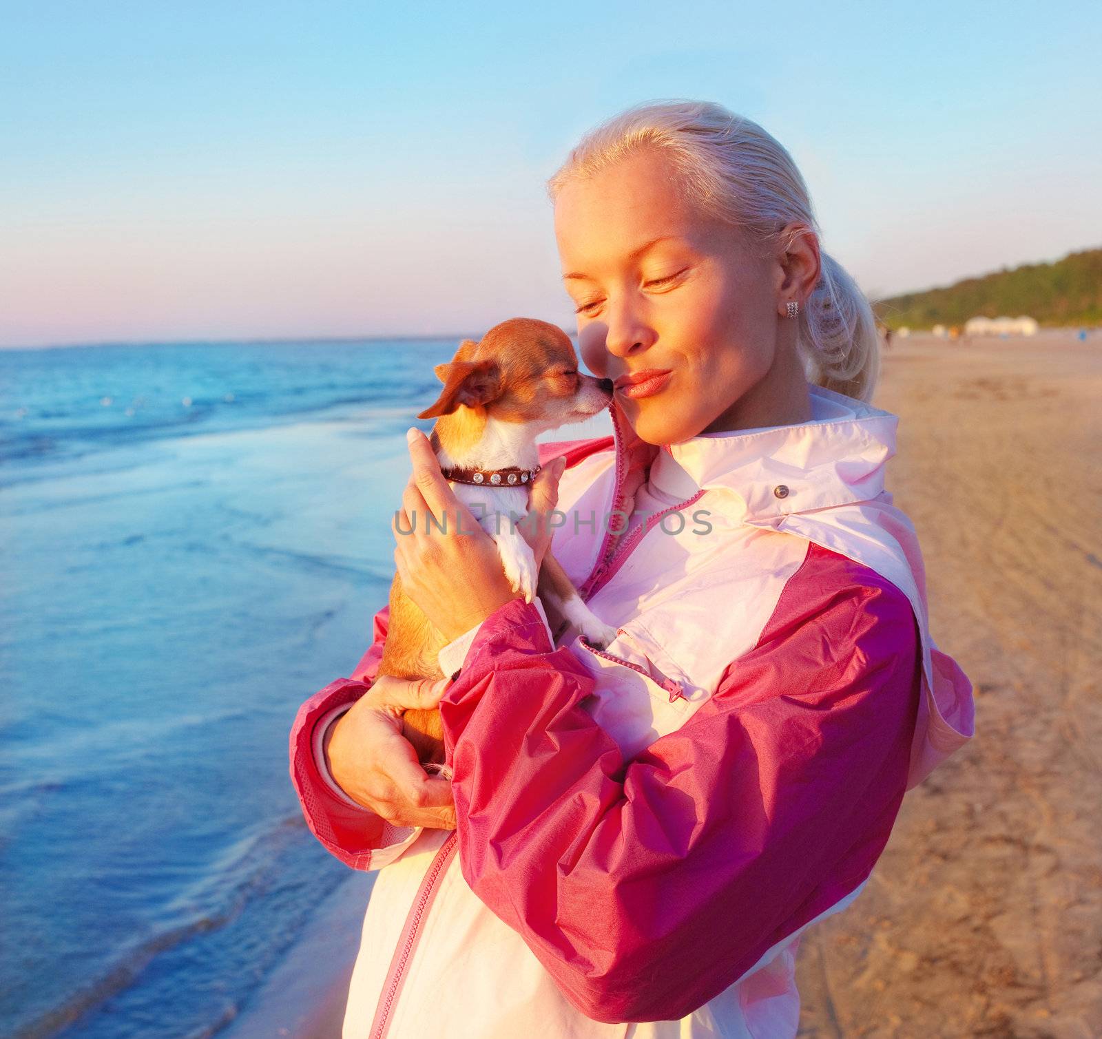 Young woman with her dog on a beach