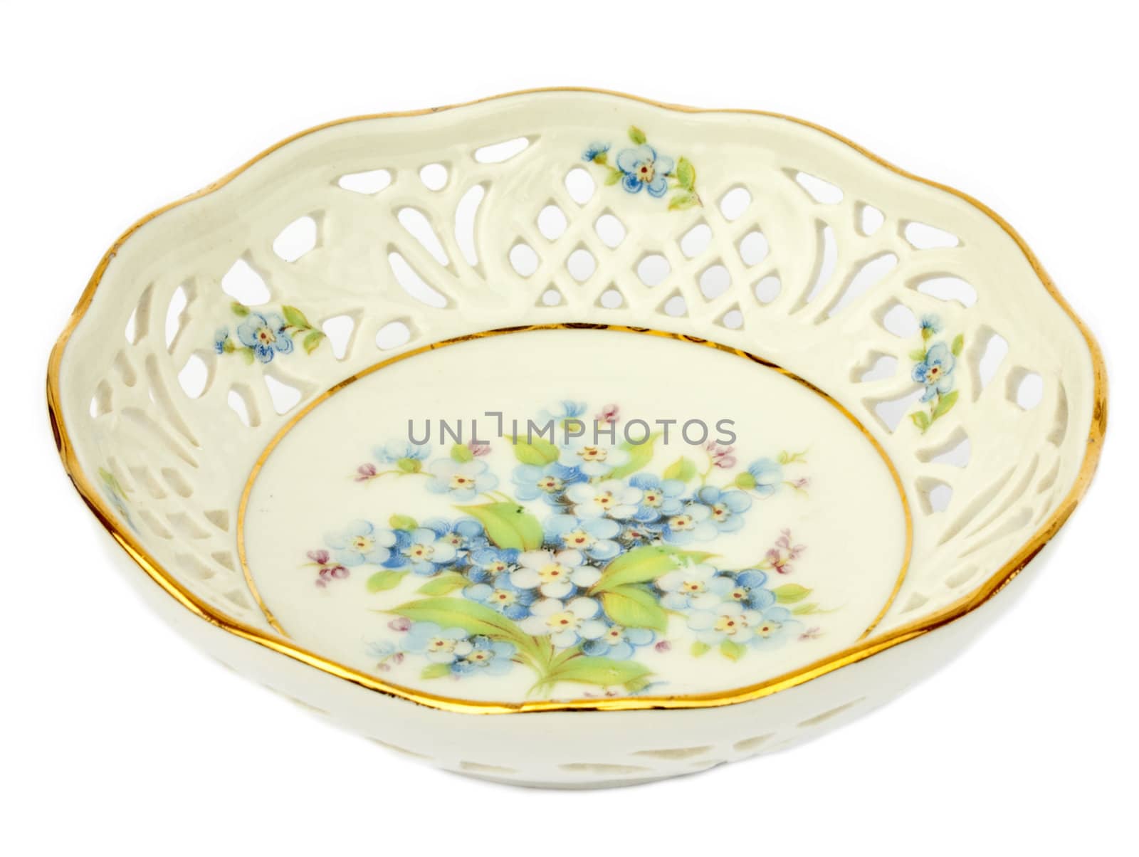 Old antique white porcelain bowl painted with blue and pink forget-me-nots
