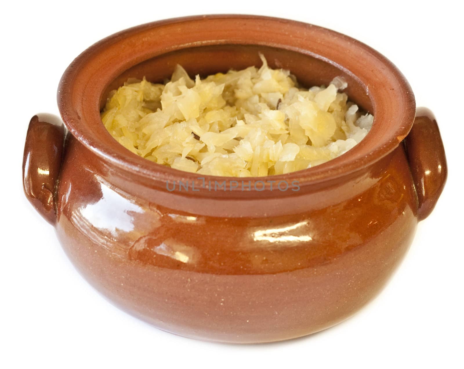 Clay pot filled with traditional homemade sauerkraut