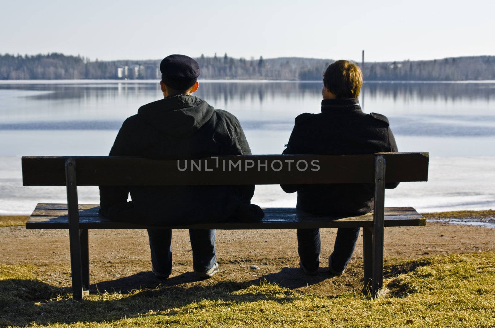 two men sitting on a bank