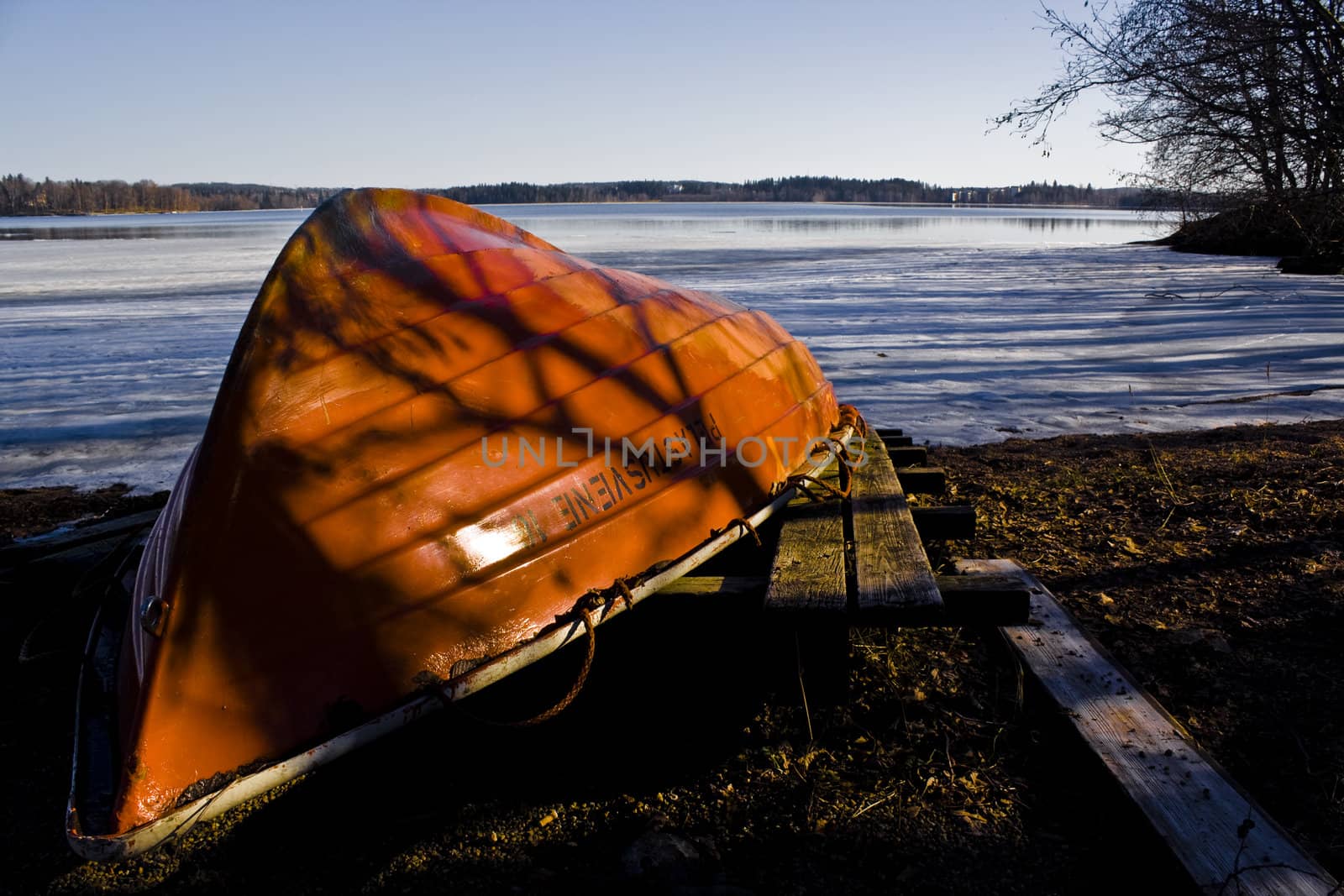 rowboat in orange in front of a sea